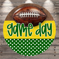 A football is displayed on a wooden background with the text "game day" written in green cursive font.