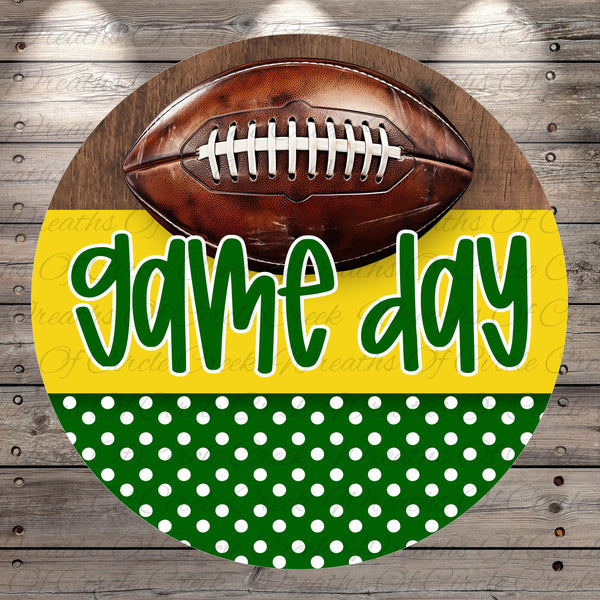 A football is displayed on a wooden background with the text "game day" written in green cursive font.