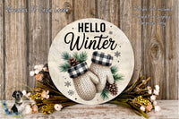 a round wooden sign with the text "HELLO WINTER" and illustrations of knit mittens and pine cones, surrounded by a floral arrangement and pine cones.