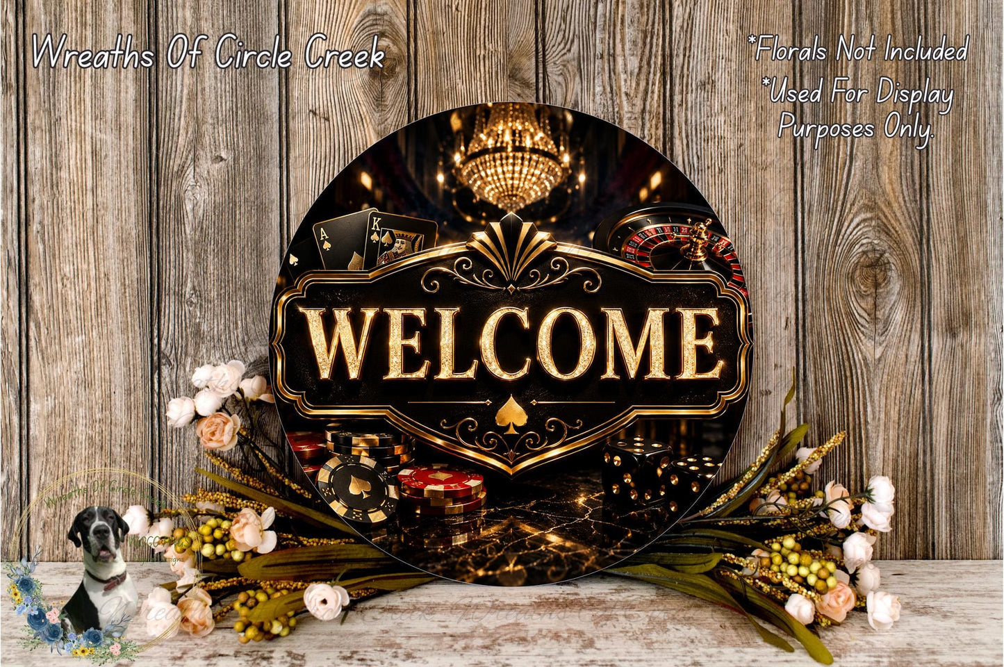 a large circular sign with the word "WELCOME" prominently displayed in the center, surrounded by various casino-themed elements such as playing cards, chips, and a chandelier. The sign is set against a rustic wooden background, with a floral arrangement of flowers and greenery placed in front of it.