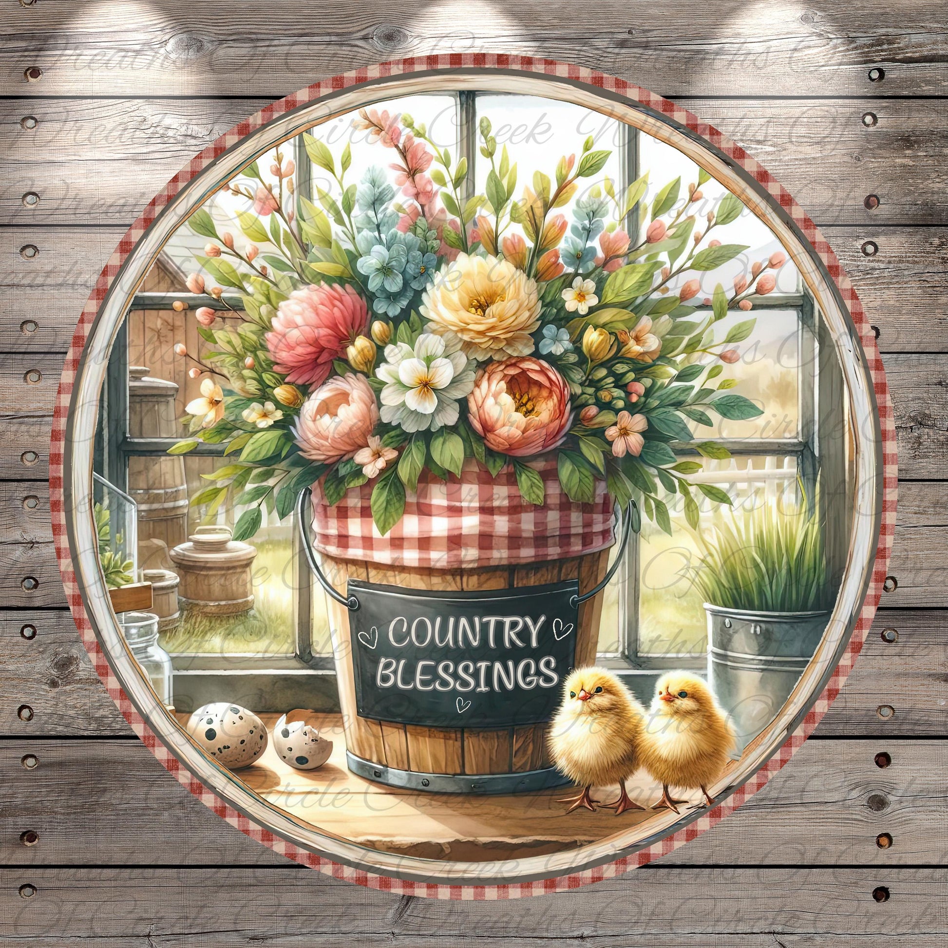 A round wooden frame with a vibrant floral arrangement inside, featuring a bucket with a sign that reads "Country Blessings". Two small chicks are perched on a wooden surface next to the bucket, and there are some eggs and a bird feeder nearby.