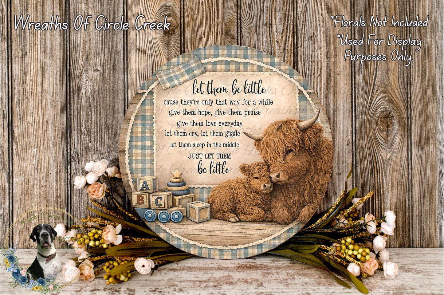 A decorative wooden plaque with a mother cow and her baby, surrounded by flowers and a baby carriage, with a quote about letting them be little.