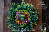 a wreath with the text "TRICK or TREAT" and various Halloween-themed decorations, including pumpkins, bats, and a spider. The wreath is set against a wooden background, and there is a small dog visible in the bottom right corner.