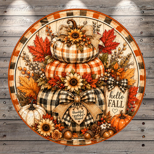 A decorative arrangement of autumn-themed elements, including pumpkins, sunflowers, leaves, and bows, set against a wooden background.