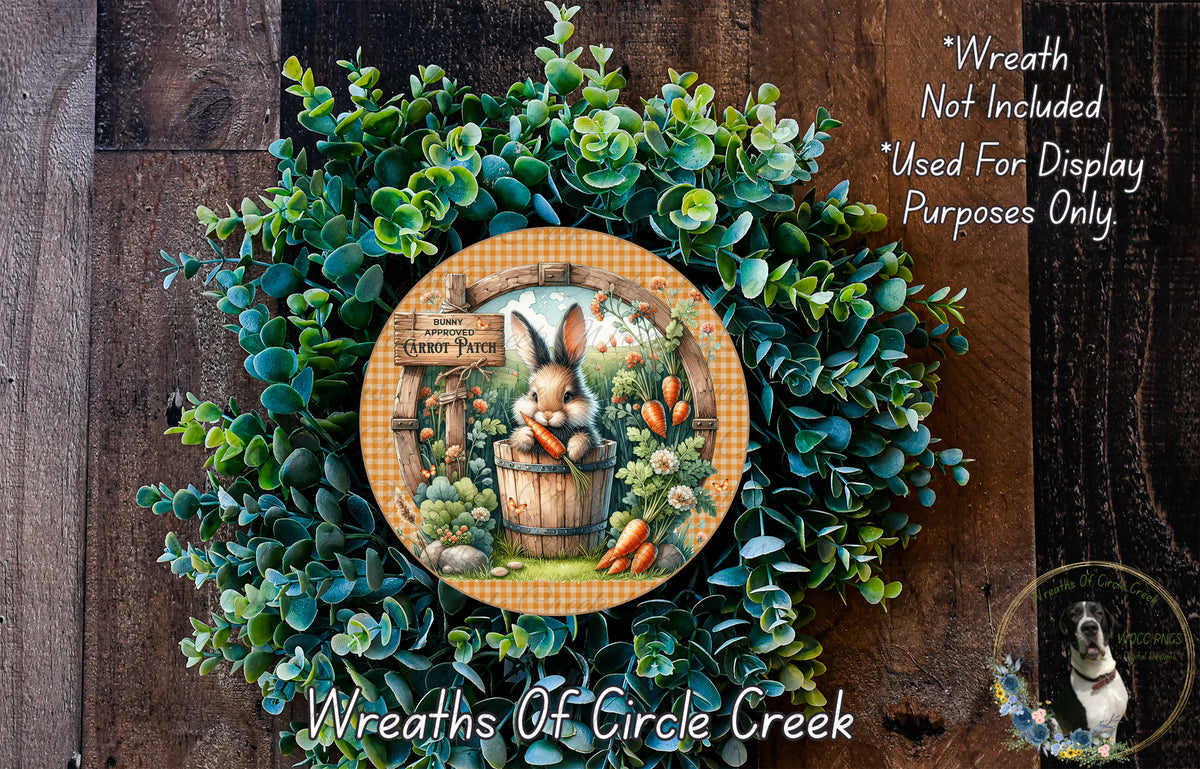 a wreath with a rabbit and carrots, surrounded by a lush green plant. The wreath is placed on a wooden surface, and there is a small dog in the bottom right corner of the image.
