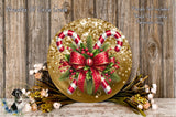 A festive Christmas wreath with candy canes, red and gold ribbons, and greenery, displayed on a wooden surface.