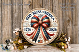 A circular wooden plaque with a patriotic design, featuring a large red, white, and blue ribbon with stars and stripes, and the text "God Bless America" and "1776" on it. The plaque is surrounded by flowers and placed on a wooden surface.