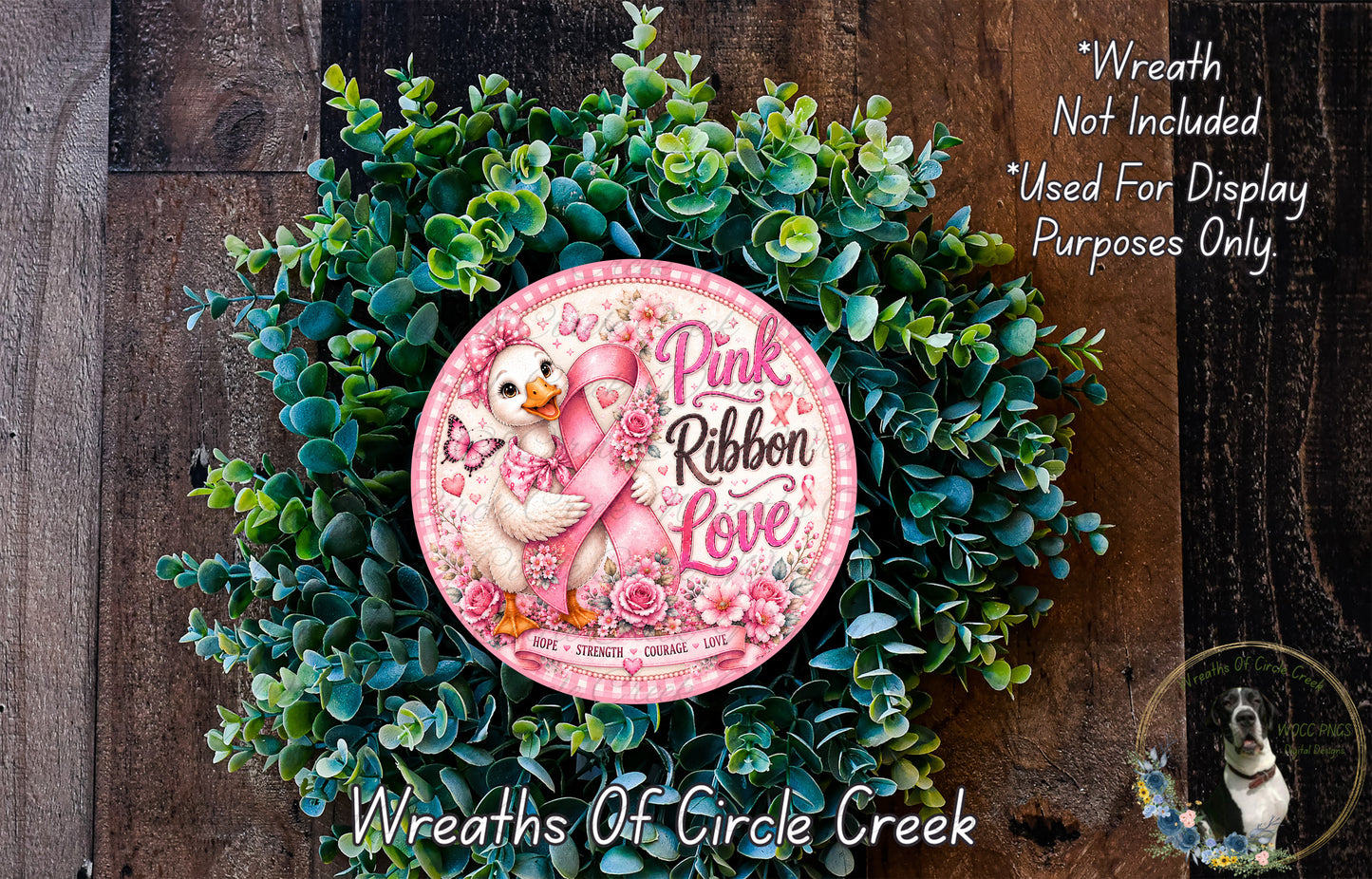 a wreath made of green leaves and flowers, with a pink ribbon and a duck holding a pink ribbon. The wreath is described as a "Wreath of Circle Creek" and is used for display purposes only.