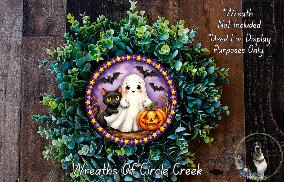 A Halloween-themed wreath made of green foliage and featuring a ghost, a black cat, and a jack-o-lantern.