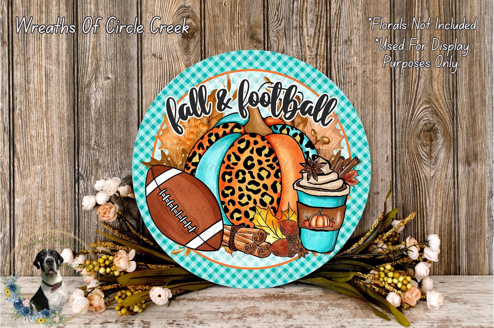 a decorative plate with a football, leopard print pumpkin, and fall-themed items, such as a cup of coffee and flowers, placed on a wooden surface.