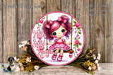 A round, decorative sign featuring a young girl with pink hair and bows, sitting on a swing surrounded by flowers and greenery.