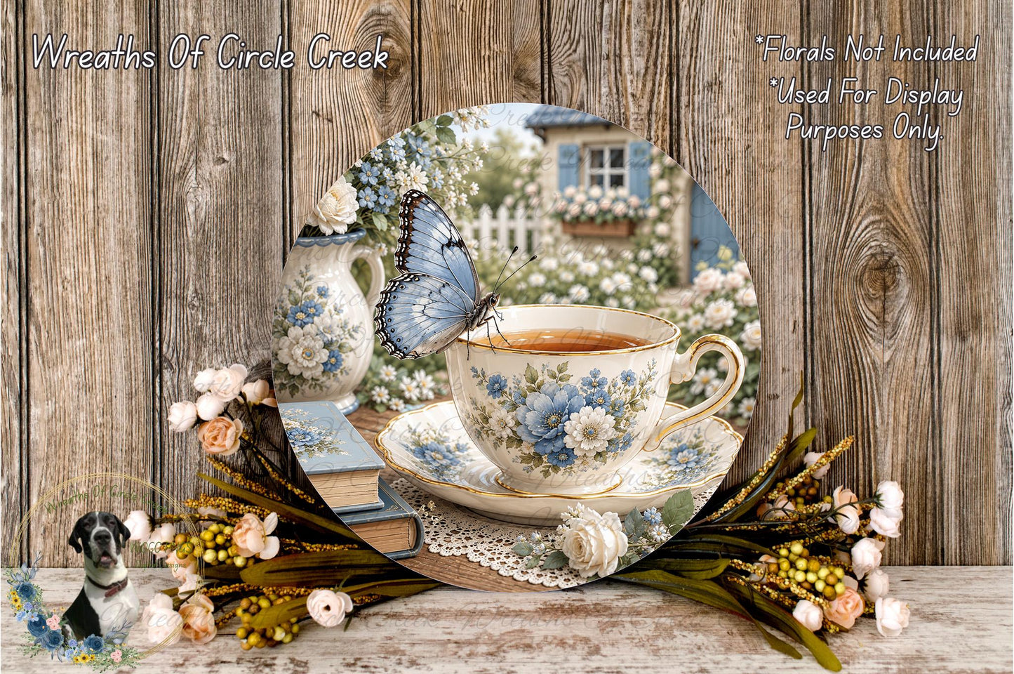 A teacup with a blue butterfly resting on it, surrounded by flowers and a wooden table, with a blurred background of a garden.