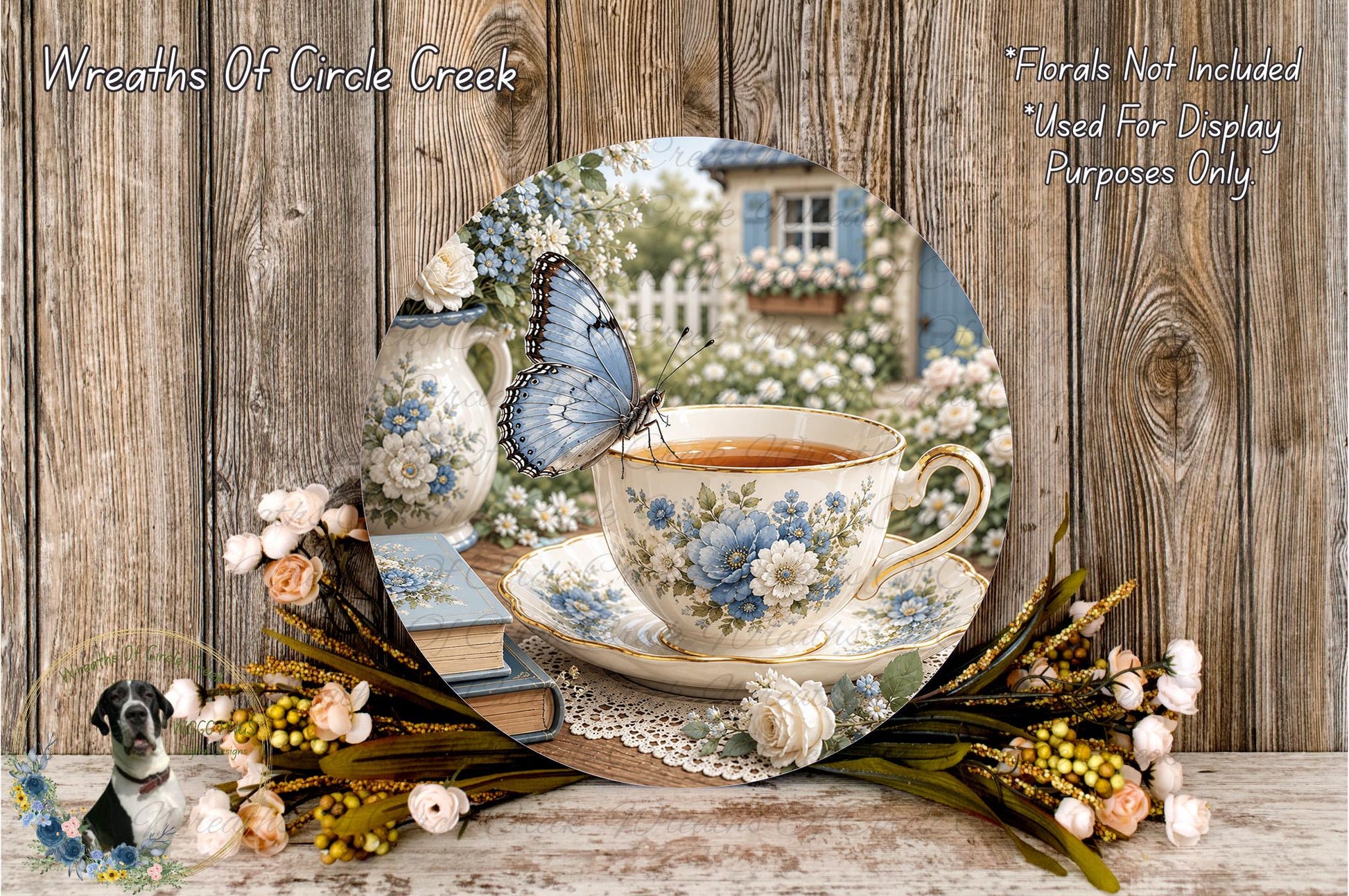 A teacup with a blue butterfly resting on it, surrounded by flowers and a wooden table, with a blurred background of a garden.