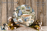 A teacup with a blue butterfly resting on it, surrounded by flowers and a wooden table, with a blurred background of a garden.