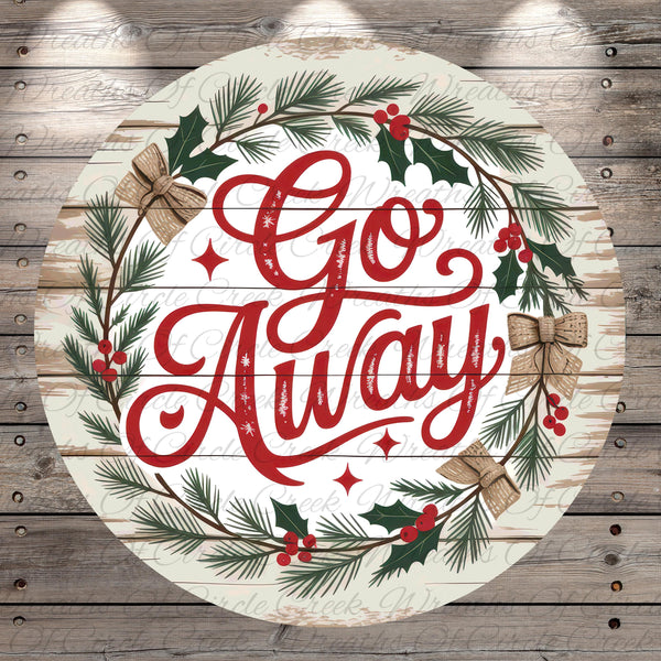 A circular wooden sign with the text "Go Away" surrounded by a wreath of pine branches, berries, and holly leaves.