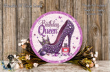 a birthday-themed wreath with a purple high-heeled shoe, surrounded by flowers and a wooden background.