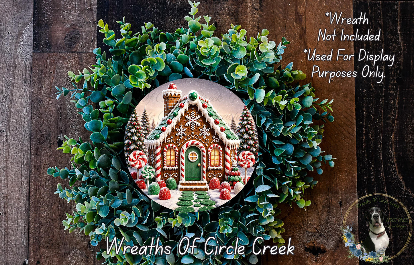 A wreath made of evergreen branches and a gingerbread house, with a caption that reads "Wreath Not Included * Used For Display Purposes Only".