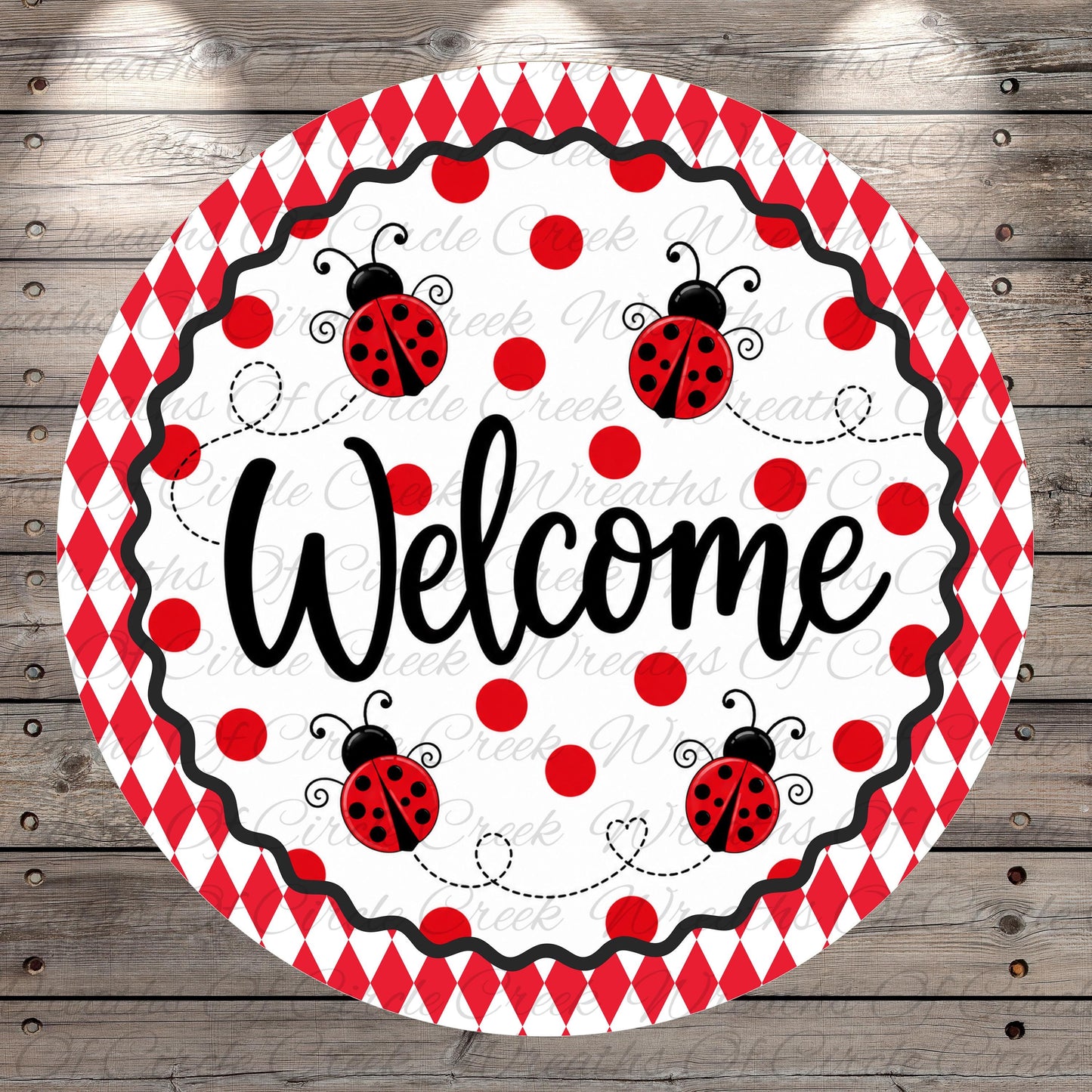 A round, red and white sign with the word "Welcome" written on it, surrounded by ladybug illustrations.