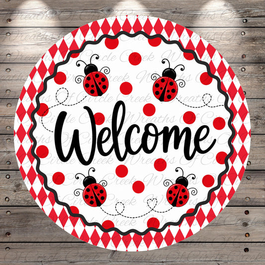 A round, red and white sign with the word "Welcome" written on it, surrounded by ladybug illustrations.
