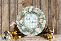 A round wreath with a "Merry Christmas & Happy New Year" message, surrounded by seashells, pine branches, and flowers, placed on a wooden surface.