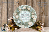 A round wreath with a "Merry Christmas & Happy New Year" message, surrounded by seashells, pine branches, and flowers, placed on a wooden surface.