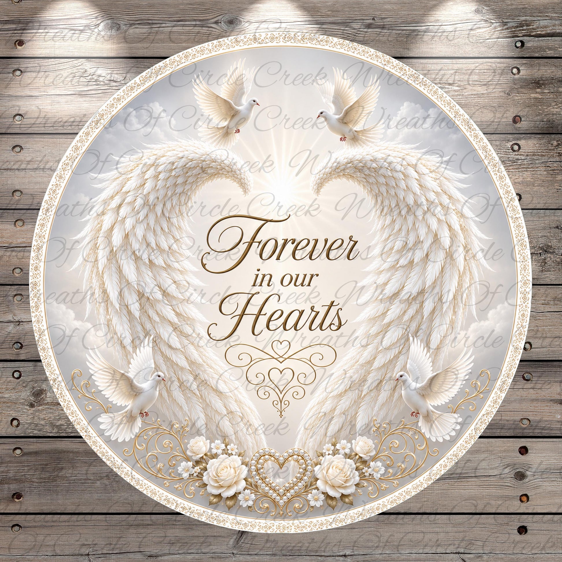 a circular design with a white background, adorned with a pair of angel wings, a heart, and a dove. The text "Forever in our hearts" is prominently displayed in the center of the design.