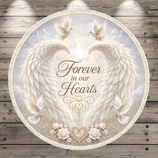 a circular design with a white background, adorned with a pair of angel wings, a heart, and a dove. The text "Forever in our hearts" is prominently displayed in the center of the design.
