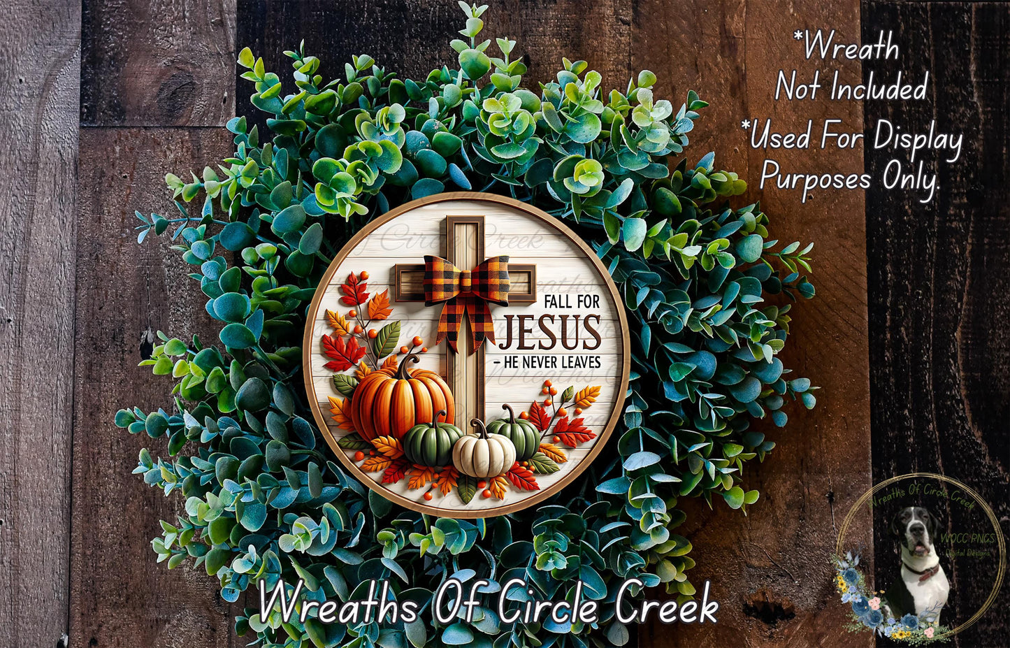 a wreath with a cross and fall-themed decorations, including pumpkins and leaves, set against a wooden background.