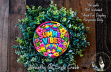 A colorful wreath made of green leaves and flowers, with a sign that says "Summer Vibes" in the center.