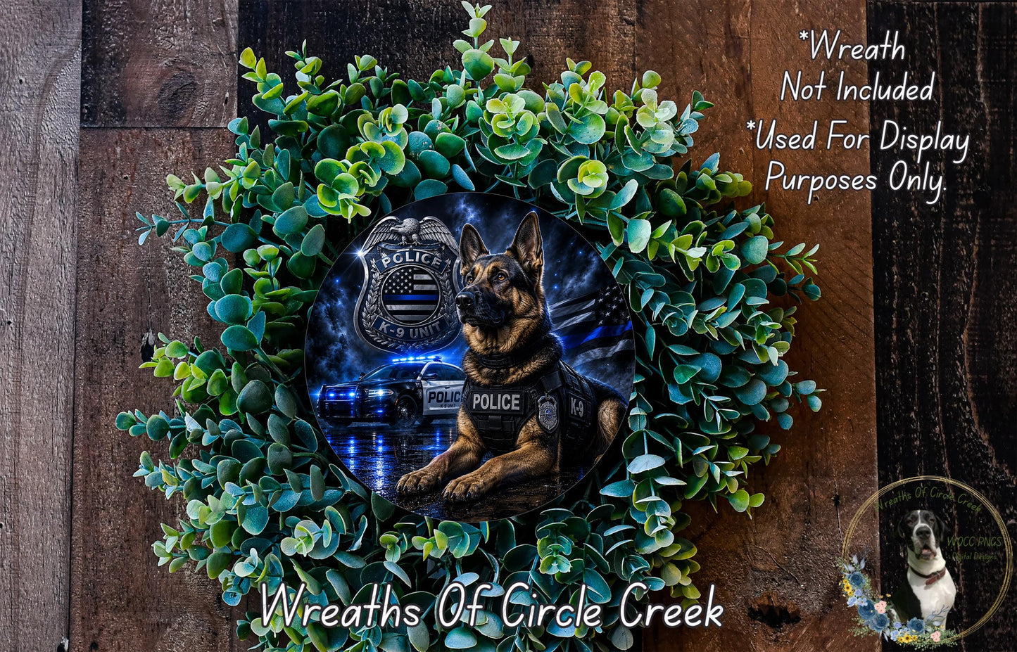 A wreath featuring a police dog, with a police badge and a police car in the background, surrounded by green foliage.
