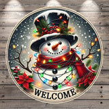 A snowman wearing a top hat and scarf, surrounded by colorful lights and flowers, with the word "WELCOME" written below.