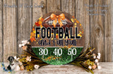 A circular sign with the text "FOOTBALL and fall y'all" and "3.0 4.0 5.0" displayed on it, surrounded by a wreath of flowers and greenery.