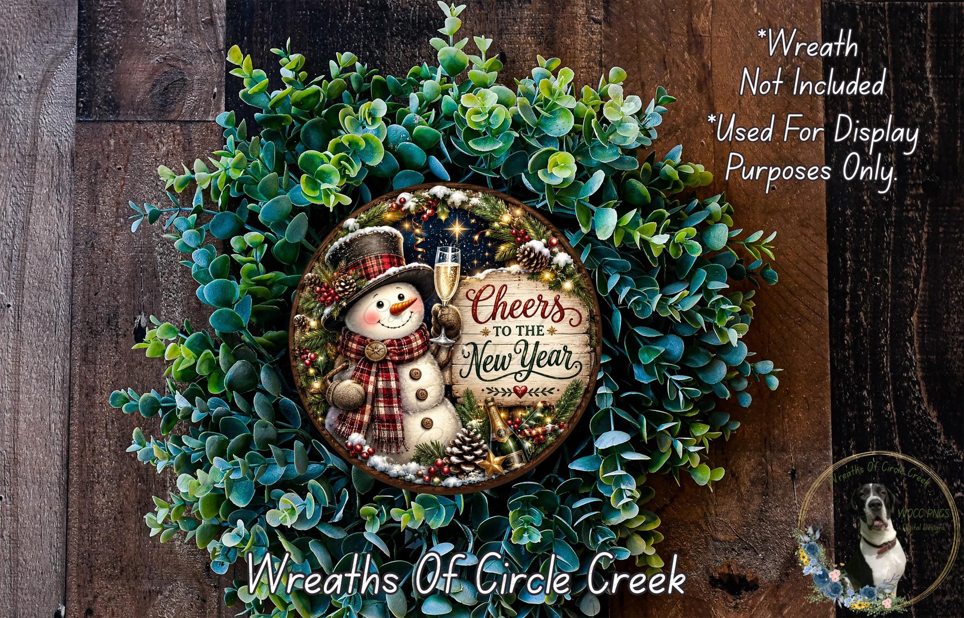 A wreath made of green foliage and featuring a snowman holding a sign that says "Cheers to the New Year".