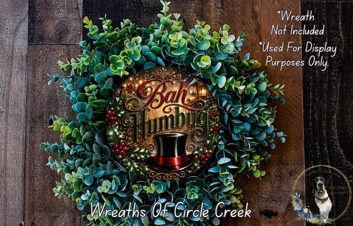 a wreath with the text "Bag Humbug" and a top hat, surrounded by greenery. The wreath is displayed on a wooden surface, and there is a small dog in the bottom right corner.