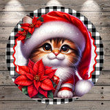 A cute cat wearing a red Santa hat and holding a poinsettia flower, set against a wooden background with a checkered border.