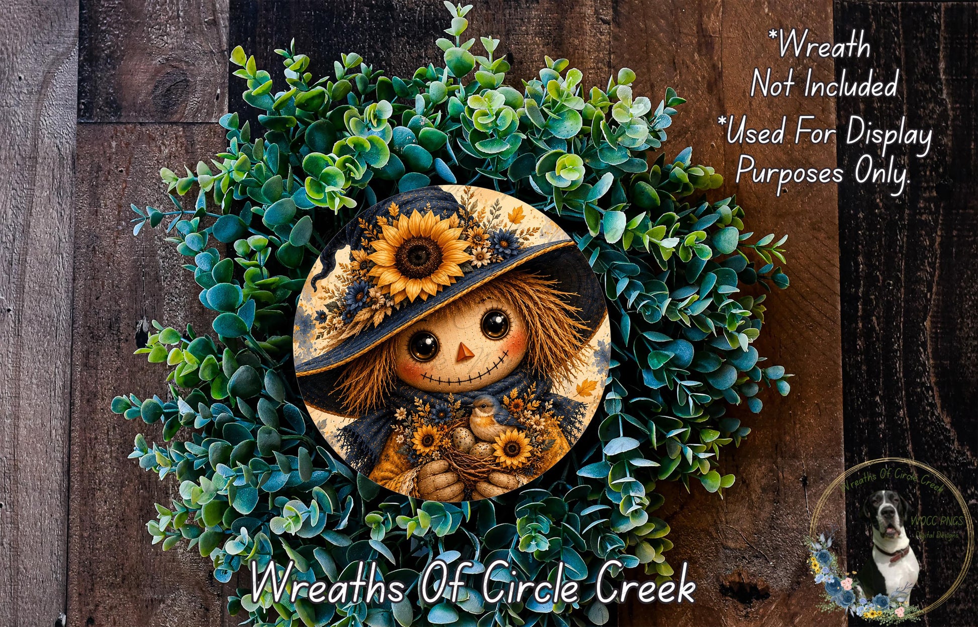 A wreath featuring a scarecrow or scarecrow-like figure surrounded by green foliage and flowers, with a sunflower and other decorative elements.