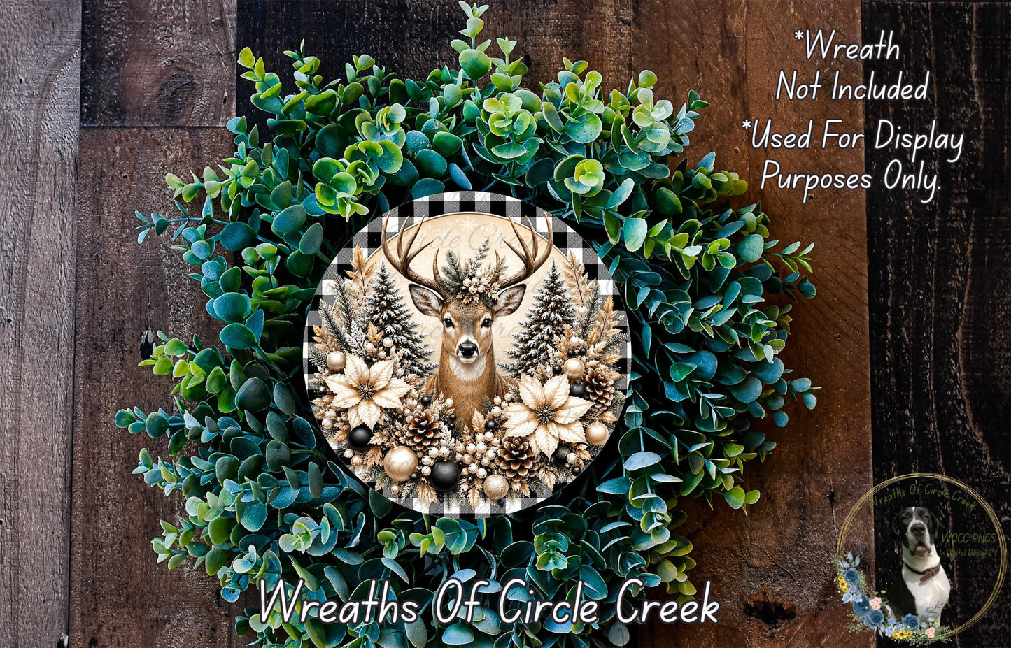 a wreath with a deer head at the center, surrounded by various greenery and flowers. The wreath is displayed on a wooden surface, and there is a small dog in the bottom right corner of the image.