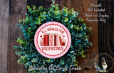 a wreath made of green leaves and a pink circular sign with the text "All Booked for Valentine's Day" and a book illustration.
