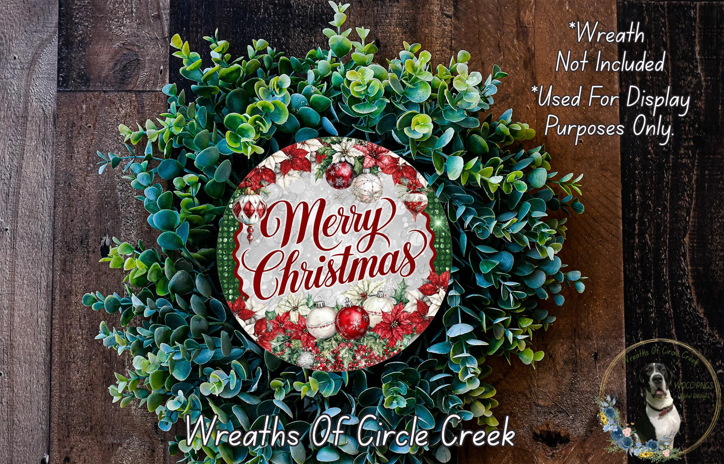A Christmas wreath made of evergreen branches and greenery, with a circular sign that says "Merry Christmas" in the center.