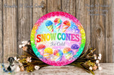 A colorful sign for "Snow Cones Ice Cold", featuring illustrations of various snow cones and a rainbow-colored border. The sign is surrounded by flowers and placed on a wooden surface.