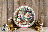 A decorative wreath with various holiday-themed items, including a snowman, a mug of hot chocolate, and a cookie, surrounded by pine cones, flowers, and other festive decorations.