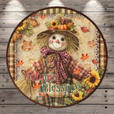 A decorative plate featuring a scarecrow with a hat, bow, and a cheerful expression, surrounded by autumn leaves, flowers, and the text "Autumn Blessings".