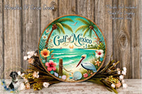 a decorative plate with a tropical beach scene, including palm trees, flowers, and a bird, set against a wooden background.