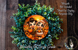 A wreath featuring two cartoon cow characters surrounded by autumn foliage, including pumpkins and sunflowers. The wreath is displayed on a wooden background, and there is a text overlay that reads "Wreath Not Included * Used For Display Purposes Only".