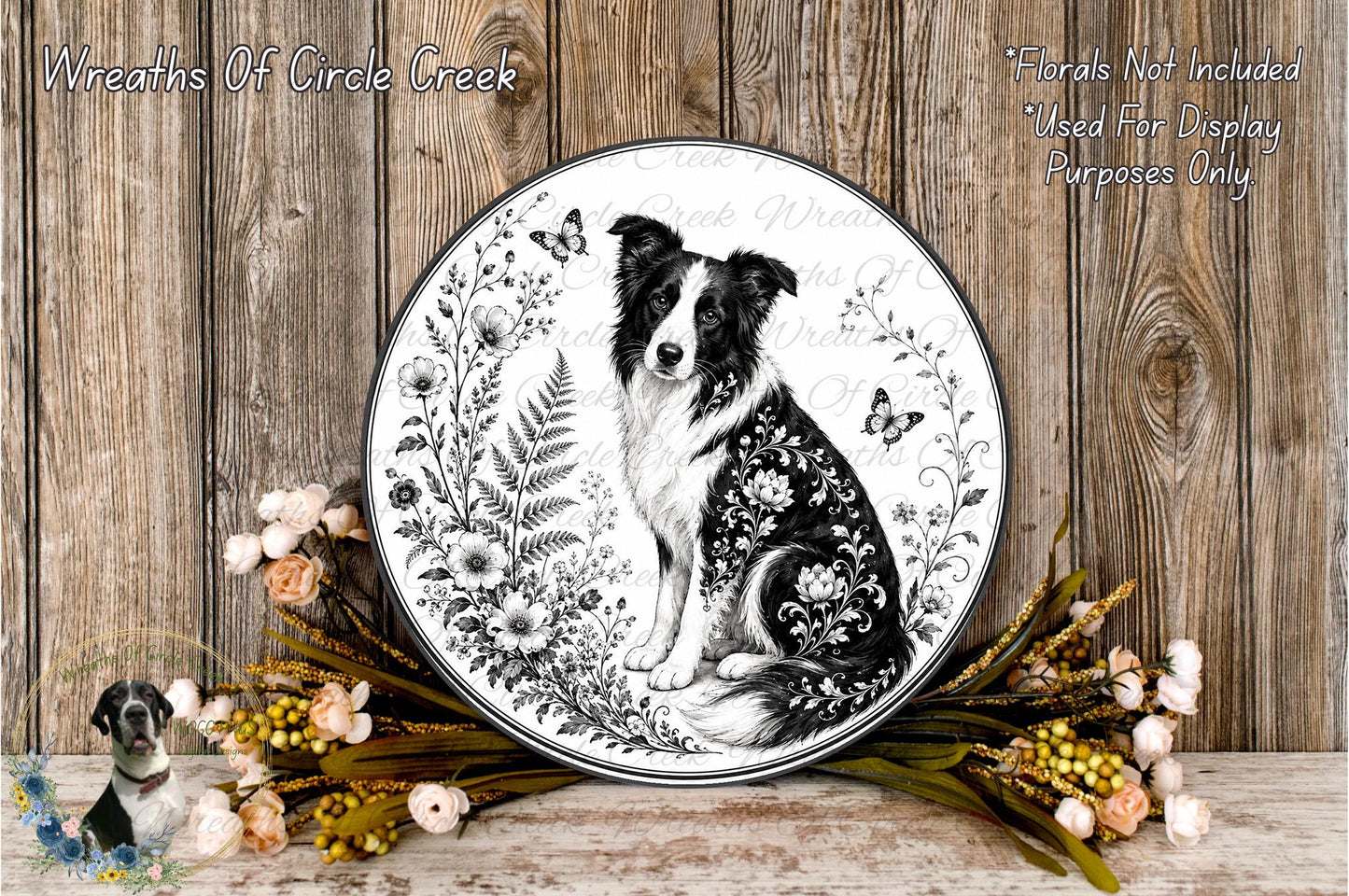 A decorative plate featuring a black and white illustration of a dog surrounded by floral elements, placed on a wooden surface with a wreath of flowers and greenery.
