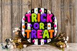 a colorful and festive Halloween decoration with the text "TRICK OR TREAT" displayed prominently. The decoration is surrounded by a floral arrangement and is set against a rustic wooden background.