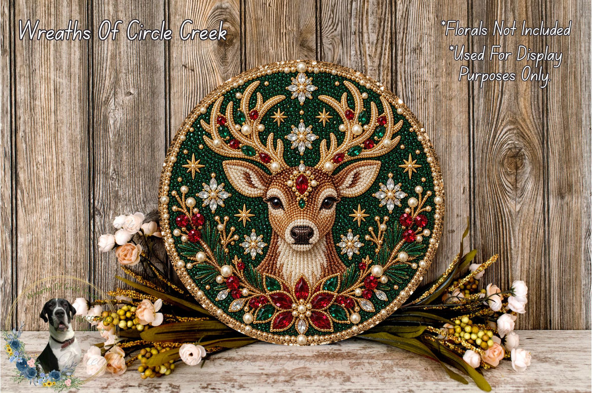 a decorative round plaque with a deer head design, surrounded by a floral arrangement and placed on a wooden surface.