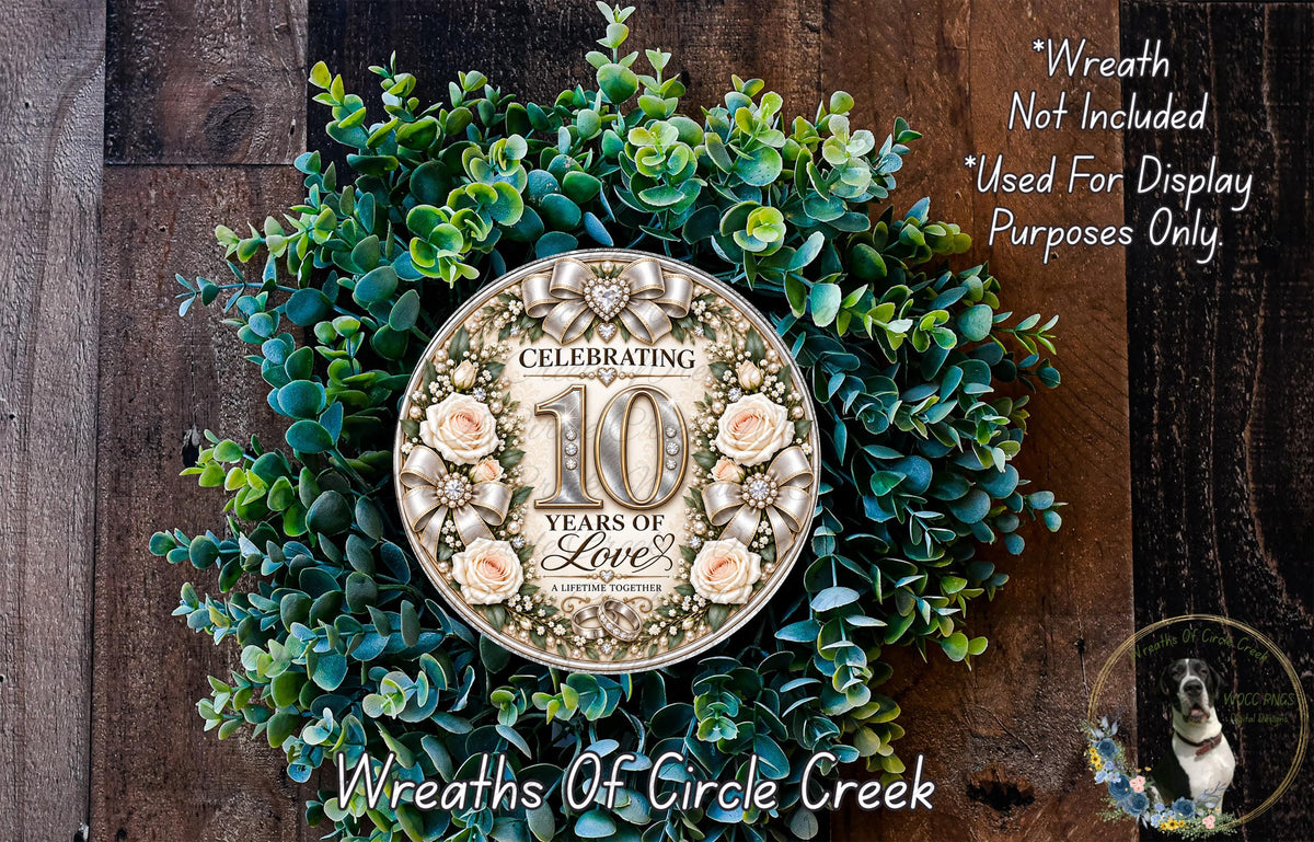 a wreath celebrating 100 years of love, with a large circular plaque in the center surrounded by greenery.