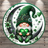 A whimsical illustration of a gnome wearing a green hat and holding a green heart, surrounded by green flowers, shamrocks, and a crescent moon.