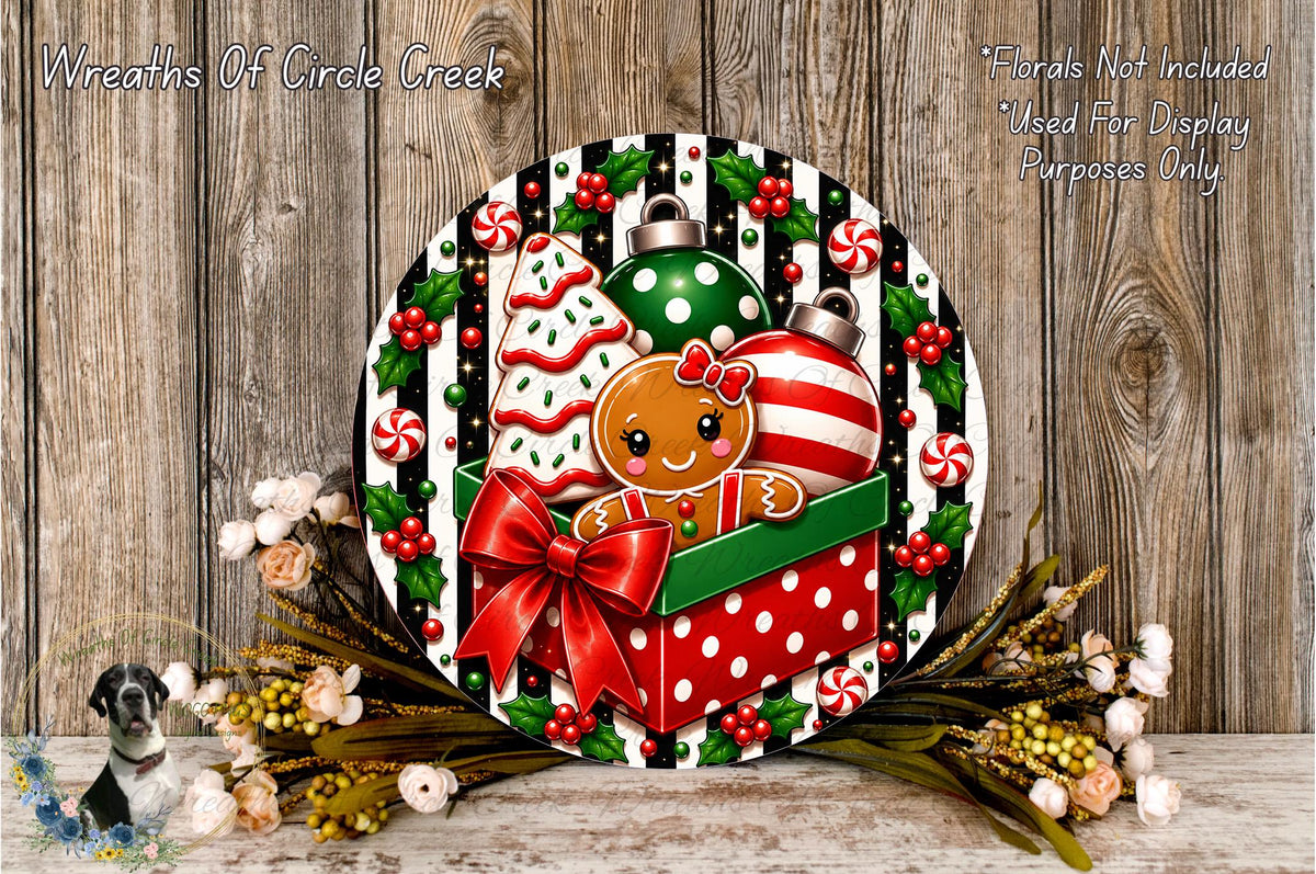 A festive wreath with a gingerbread man, Christmas ornaments, and a bow, set against a wooden background with a floral arrangement.